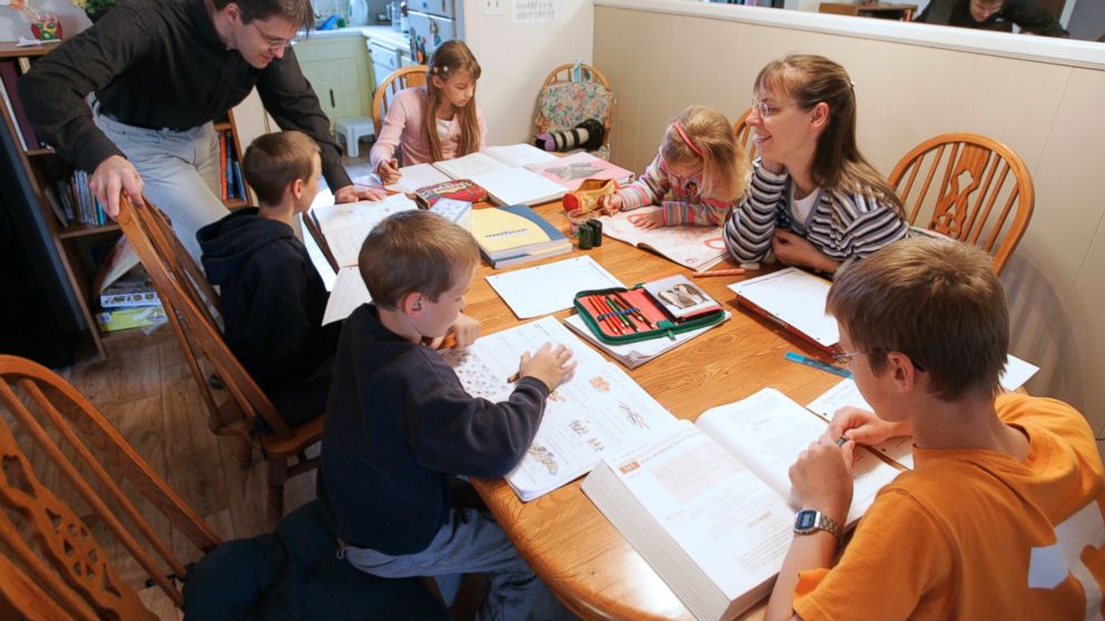 This March 13, 2009 file photo shows Uwe Romeike, top left, and his wife Hannelore, second from right, teaching their children at their home in Morristown, Tenn. An attorney for a German couple who lost their bid for U.S. asylum in order to home-school their seven children says deportation proceedings against the family have been deferred indefinitely, March 4, 2014.