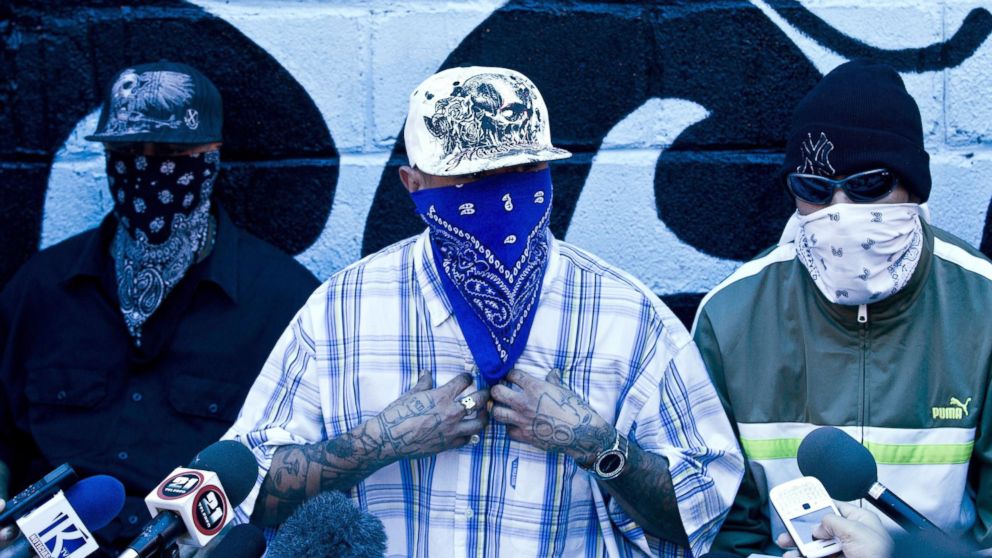 PHOTO: Masked members of the 18th Street gang give a press conference inside the San Pedro Sula prison in Honduras, May 28, 2013. 