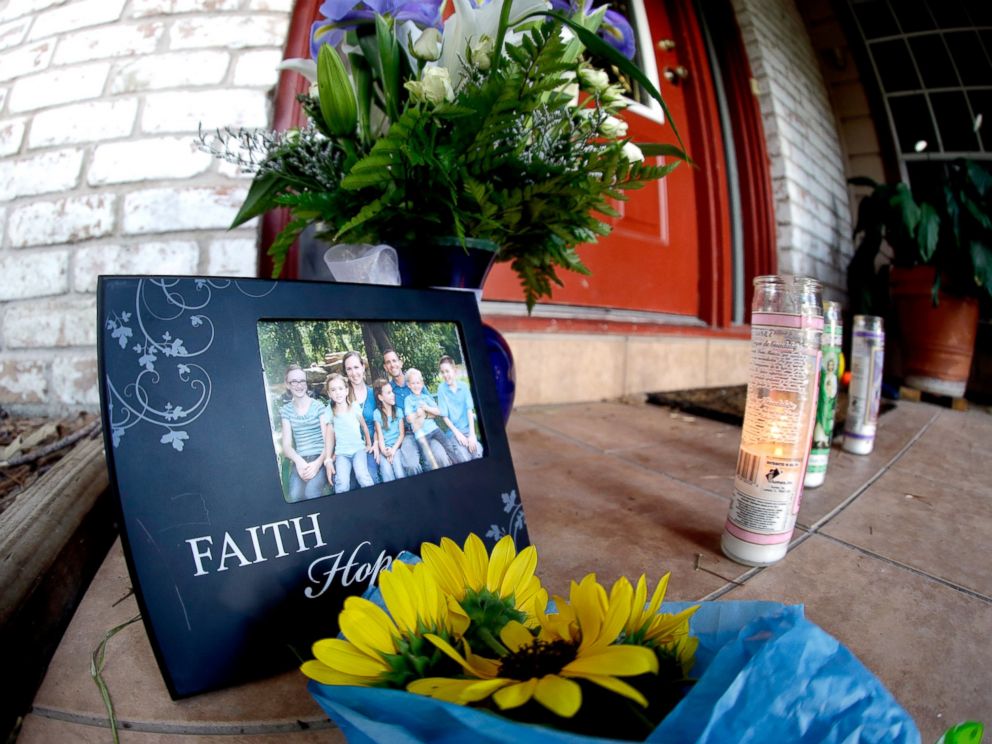PHOTO: A photograph, flowers and candles are left on the porch where a fatal home shooting took place, July 10, 2014, in Spring, Texas.