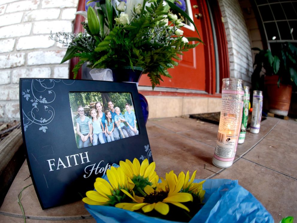 PHOTO: A photograph, flowers and candles are left on the porch where a fatal home shooting took place, July 10, 2014, in Spring, Texas. 