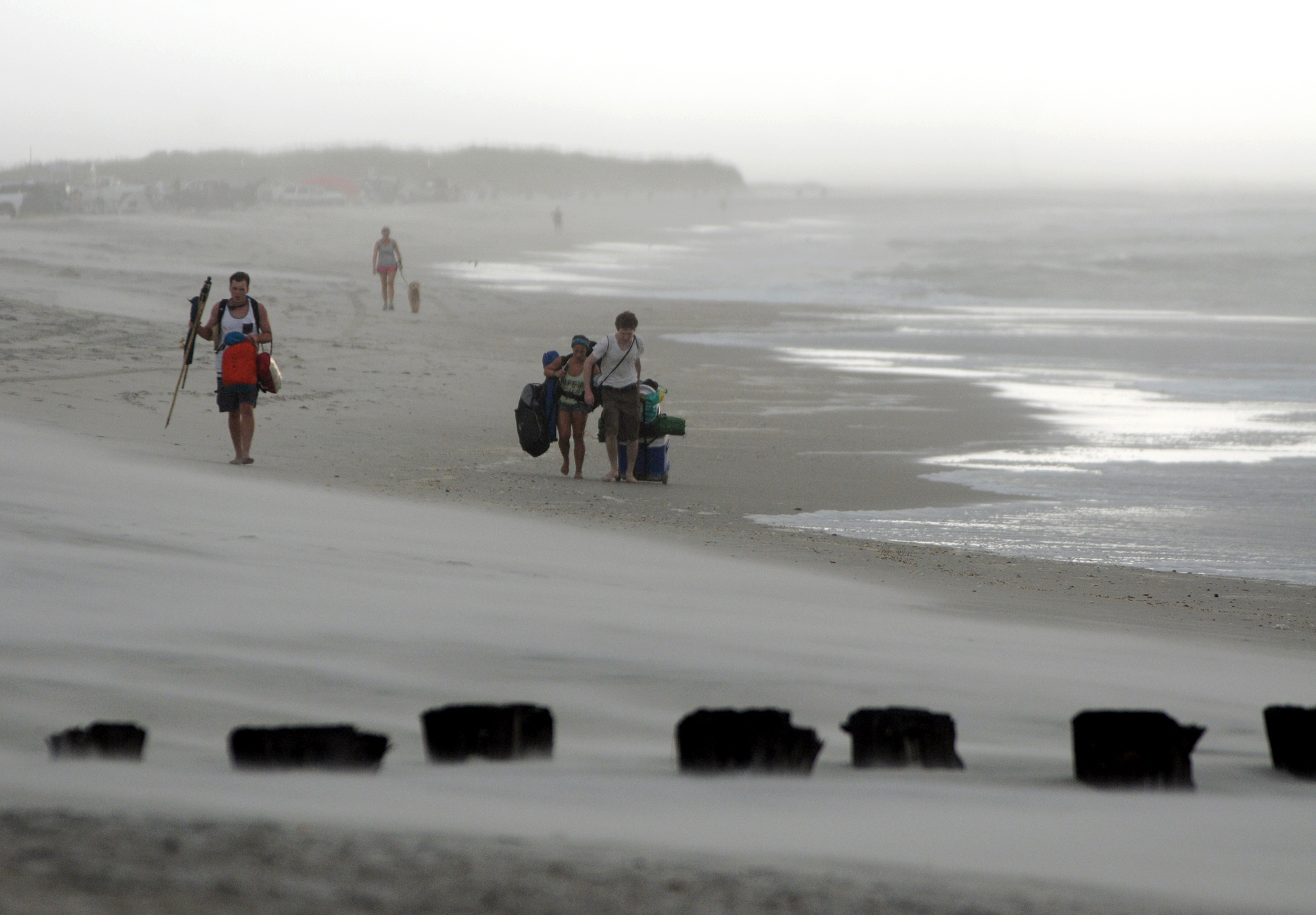PHOTO: Clouds and rains move in as beachgoers leave Freeman Park at the north end of Carolina Beach, N.C., July 3, 2014. 