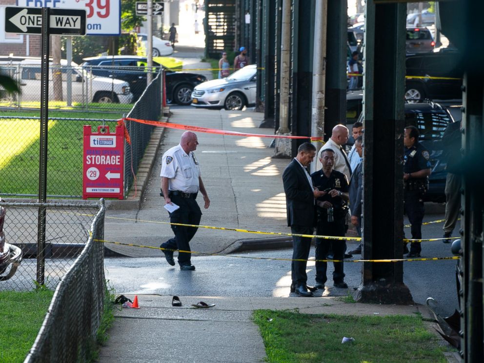 PHOTO: Police stand near the crime scene where the leader of a New York City mosque has been fatally shot and an associate has been wounded in a brazen daylight attack, Aug. 13, 2016. 