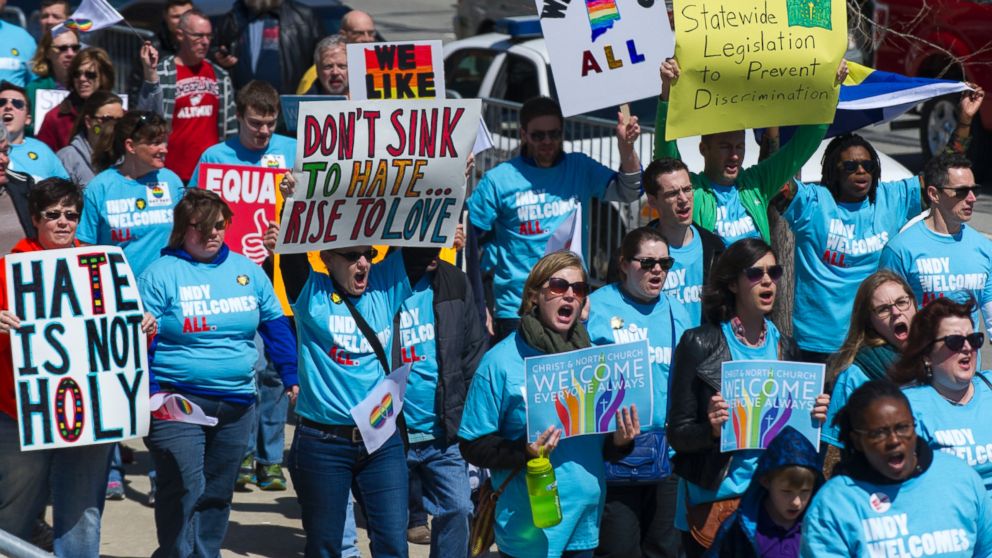 Opponents of Indiana Senate Bill 101, the Religious Freedom Restoration Act, march towards Lucas Oil Stadium in Indianapolis on Saturday, April 4, 2015 to push for a state law that specifically bars discrimination based on sexual orientation or gender identity.