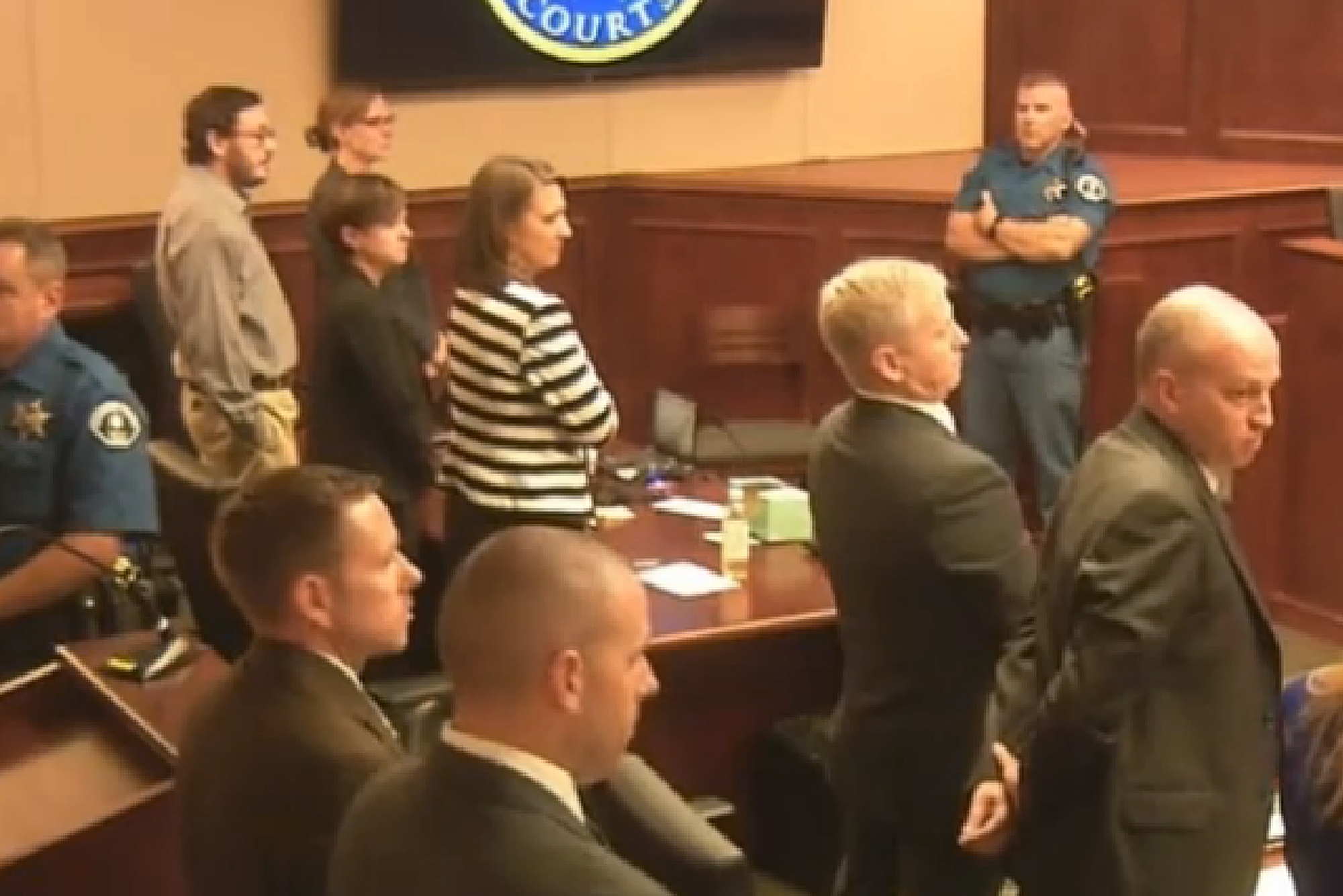 PHOTO: Defendant James Holmes, top left in tan shirt, defense attorneys and prosecuting attorneys watch as the jury exits the courtroom after delivering their sentencing verdict in the Colorado theater shooting trial in Centennial, Colo.,Aug. 7, 2015.