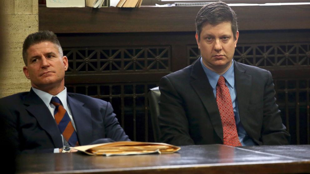 Chicago Police officer Jason Van Dyke, right, charged with murder in the 2014 videotaped shooting death of black teenager Laquan McDonald, sits in court with his attorney, Dan Herbert, at the Leighton Criminal Court Building in Chicago, March 23, 2016, for a status hearing in his case.