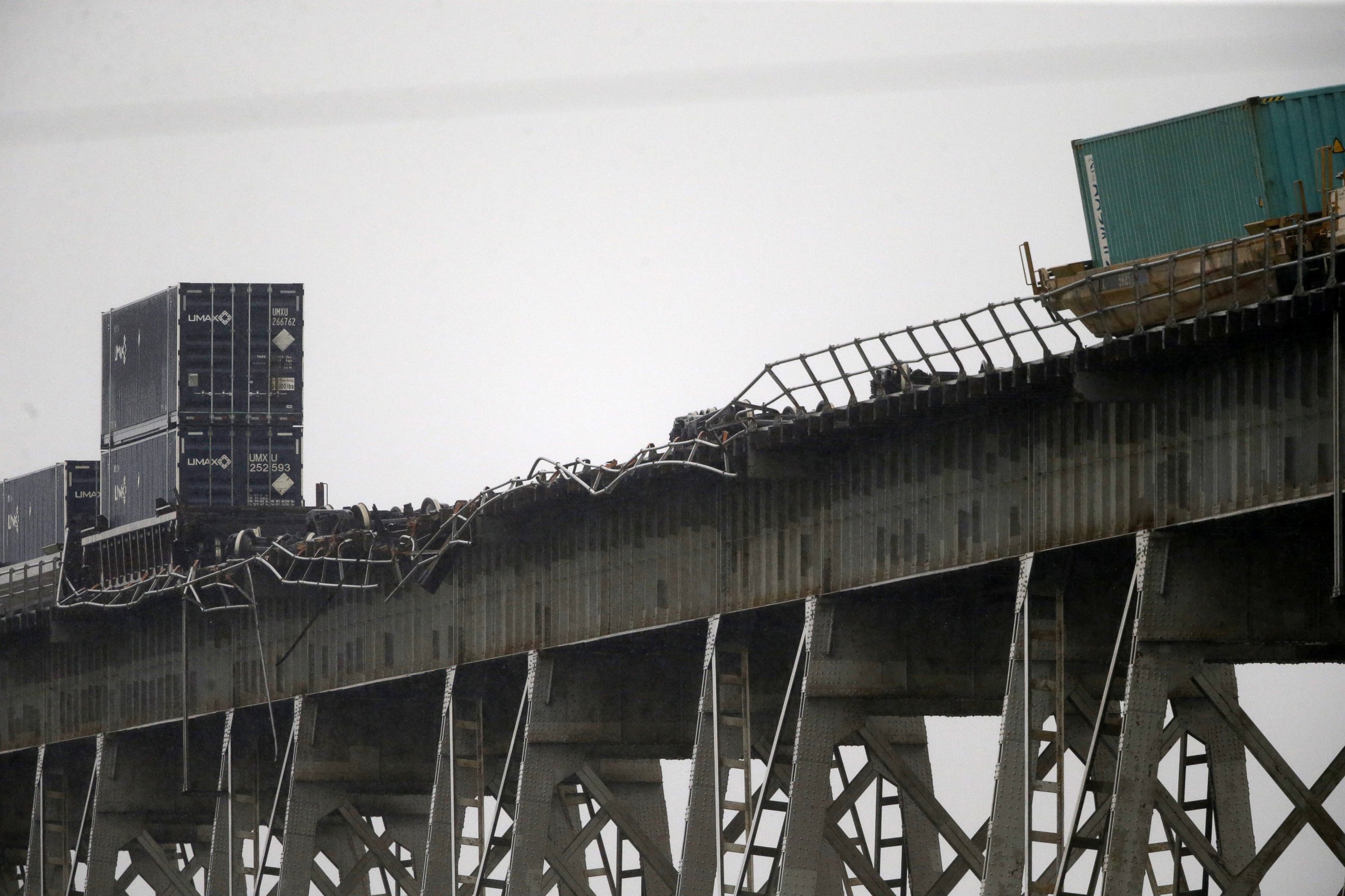 PHOTO: Broken railing and train cars are seen on the Huey P. Long Bridge, which crosses over the Mississippi River, after several cars toppled from high winds in Jefferson Parish, La., just outside New Orleans, April 27, 2015.