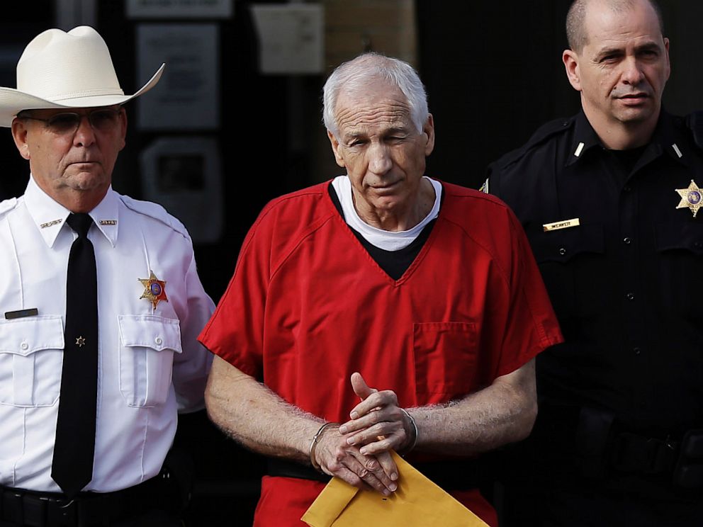 PHOTO: Former Penn State University assistant football coach Jerry Sandusky, center, is taken from the Centre County Courthouse after being sentenced in Bellefonte, Pa., Oct. 9, 2012.