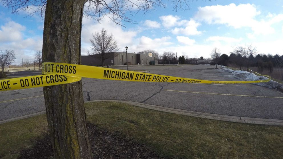 Police tape surrounds the area of a random shooting, Feb. 21, 2016, in Kalamazoo, Mich. 
