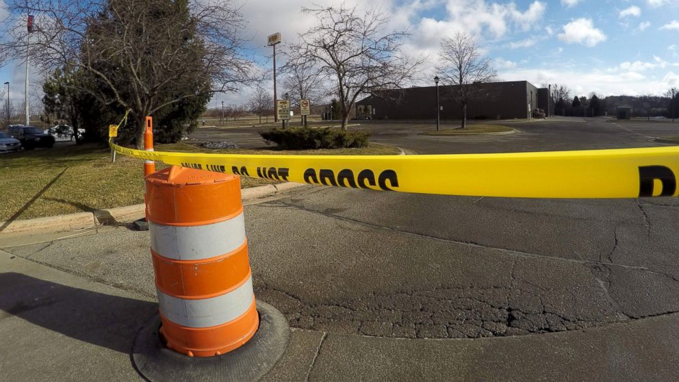 Police tape surrounds the area of a random shooting, Feb. 21, 2016, in Kalamazoo, Mich.