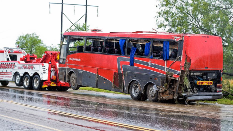 A damaged OGA Charters bus is hauled away after a fatal rollover, May 14, 2016, south of the Dimmit-Webb County line on U.S. 83N in Texas.