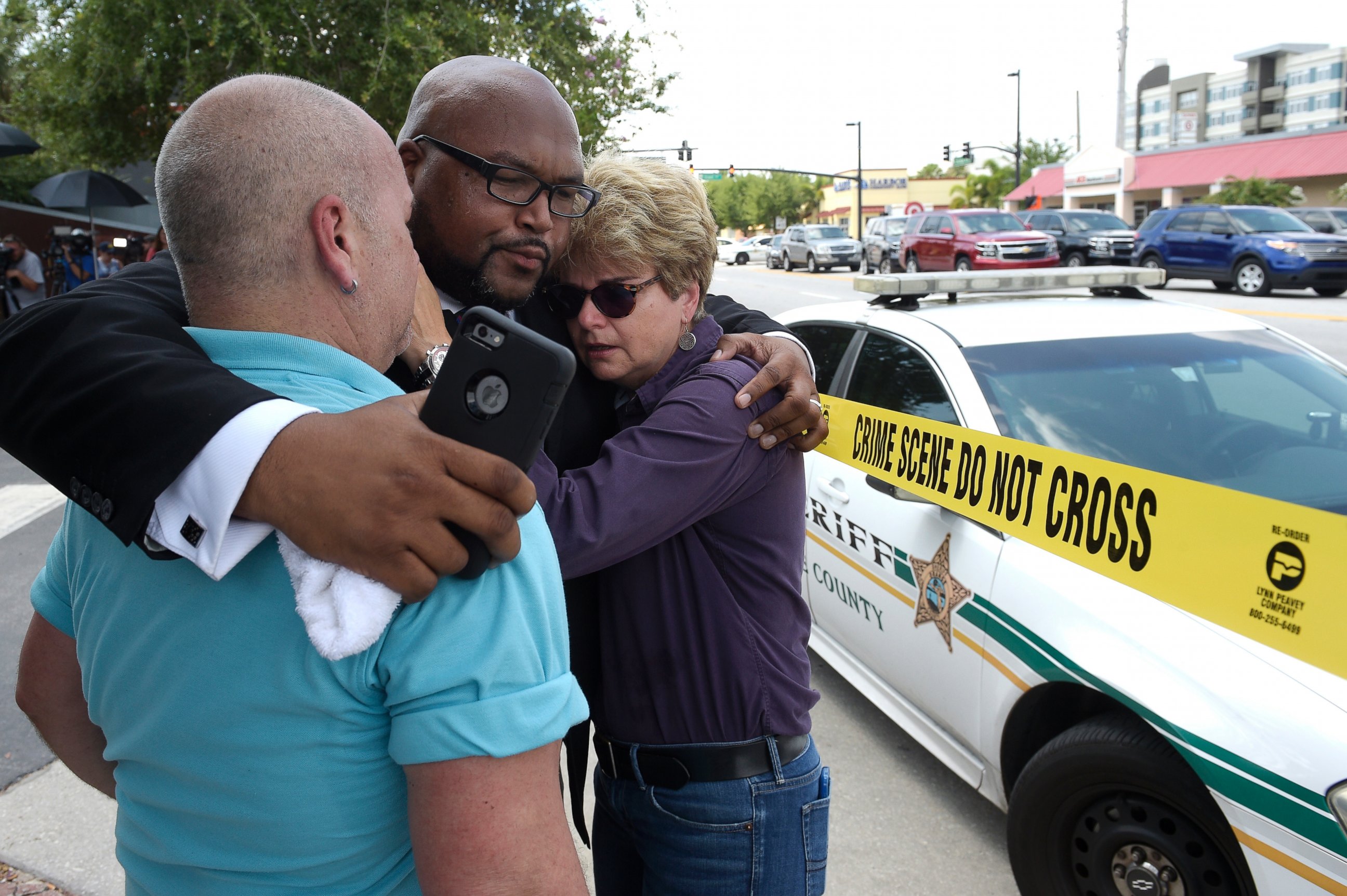 PHOTO: (L-R) Terry DeCarlo, executive director of the LGBT Center of Central Florida, Kelvin Cobaris, pastor of The Impact Church, and Orlando City Commissioner Patty Sheehan console each other after a shooting in Orlando, Fla., June 12, 2016.