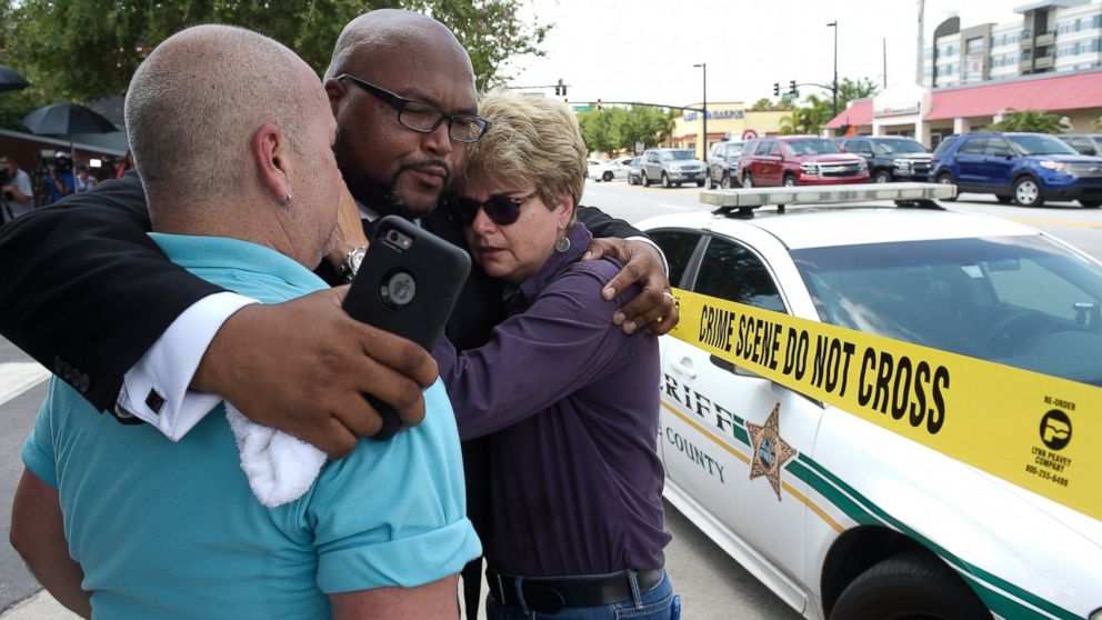 PHOTO: (L-R) Terry DeCarlo, executive director of the LGBT Center of Central Florida, Kelvin Cobaris, pastor of The Impact Church, and Orlando City Commissioner Patty Sheehan console each other after a shooting in Orlando, Fla., June 12, 2016.