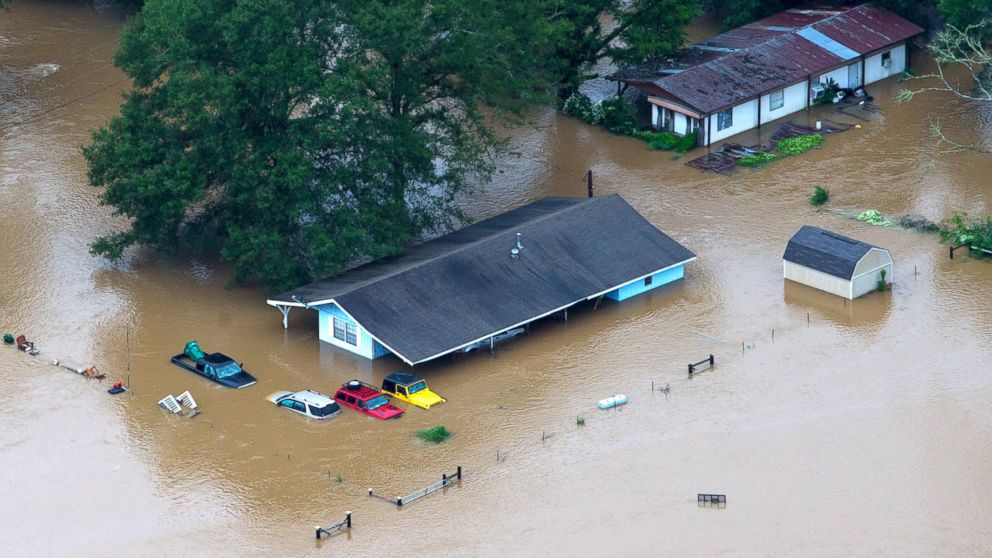 In this aerial photo, rescue officials and civilians alike work to pull people from their flooded homes along the flooded Tangipahoa River near Amite, Independence, Tickfaw and Robert, Louisiana, Aug. 13, 2016. 