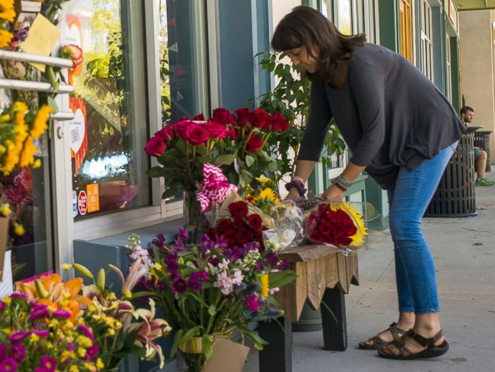 PHOTO: A woman leaves a bouquet of flowers at a makeshift memorial for store co-owner Jillian Johnson at Red Arrow Workshop in River Ranch in Lafayette, La., July 24, 2015. 