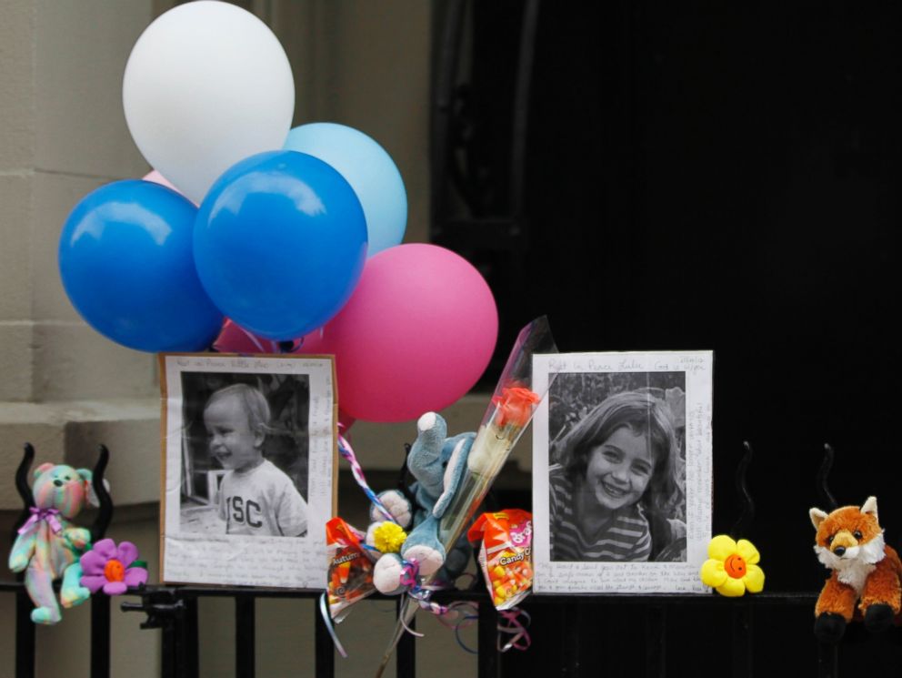 PHOTO: Photographs of six-year-old Lucia Krim and her 2-year-old brother, Leo, are displayed alongside balloons and stuffed animals at a memorial outside the apartment building were they lived in New York, Oct. 27, 2012.
