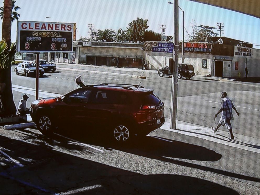 PHOTO: In this image made from security video footage provided by the Los Angeles County Sheriff, a man, right, walks with a gun in his hand, Dec. 12, 2015 in Lynwood, Calif.