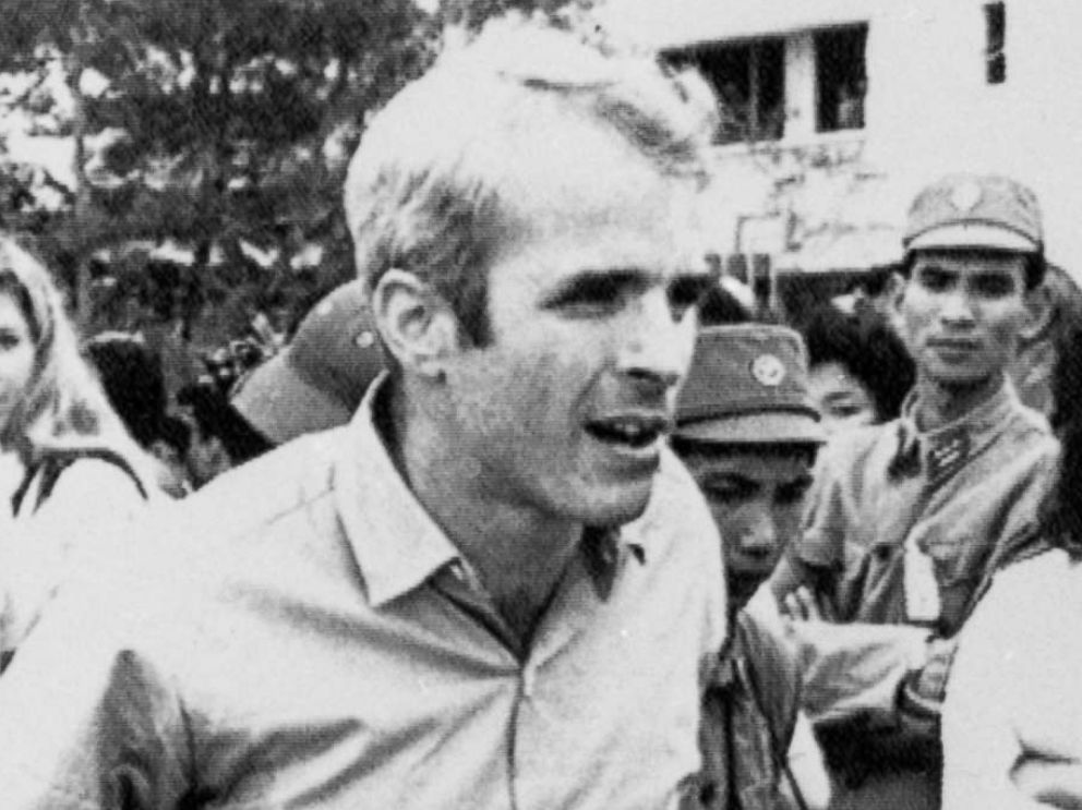 PHOTO: John McCain is escorted after he was released as a POW by Lt. Cmdr. Jay Coupe Jr., public relations officer, on March 14, 1973 to Hanoi's Gia Lam Airport.  