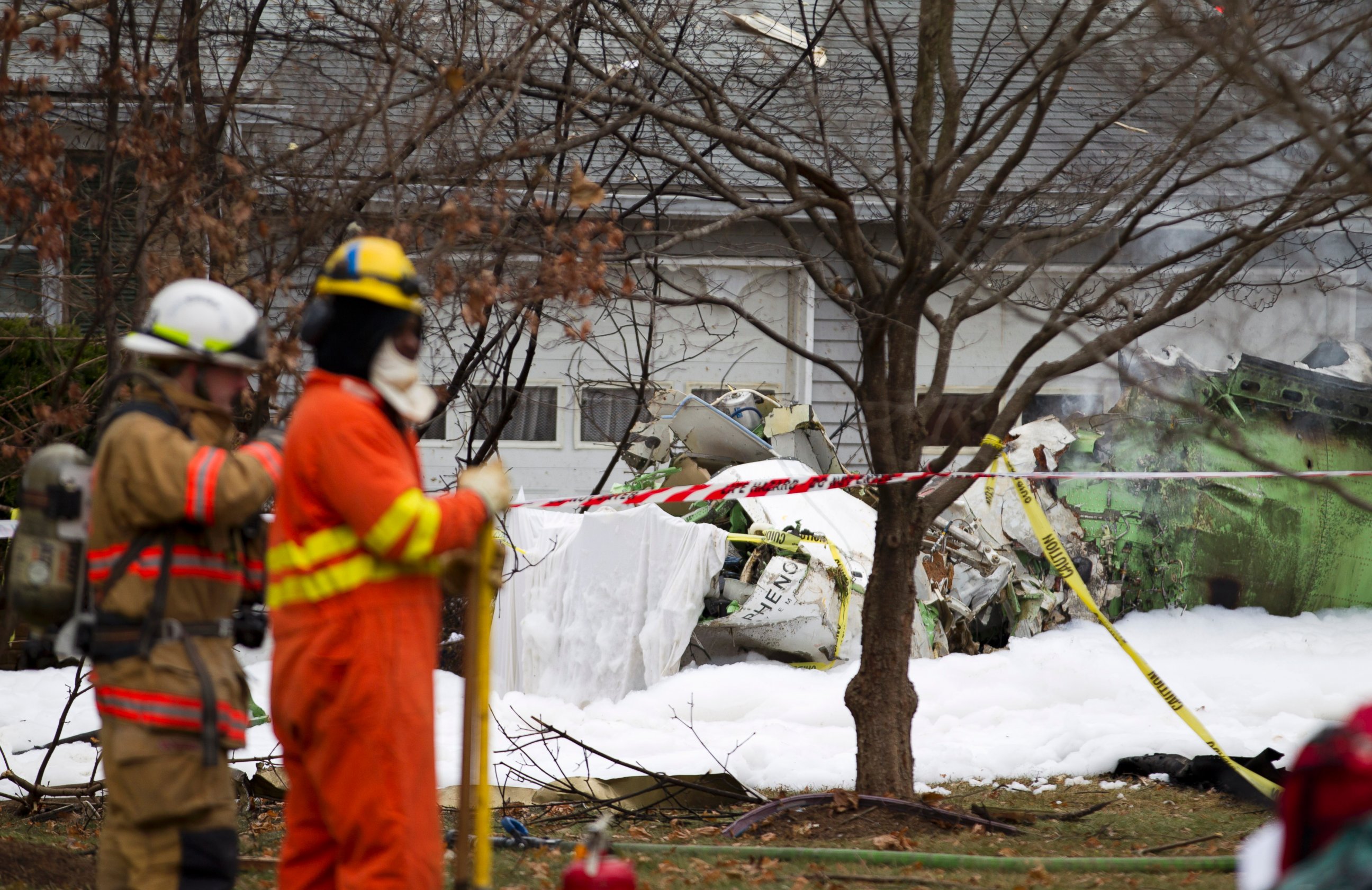 PHOTO: The wreckage of a small private jet sits in a driveway after crashing into a neighboring house in Gaithersburg, Md. on Dec. 8, 2014.