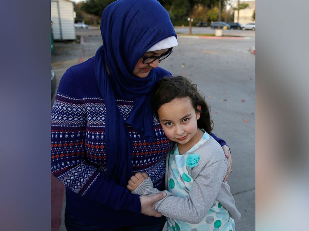 PHOTO: Sofia Yassini, 8, right, gets a hug from her mother Melissa Yassini after posing for a photo outside a mosque in Richardson, Texas, Dec. 11, 2015.