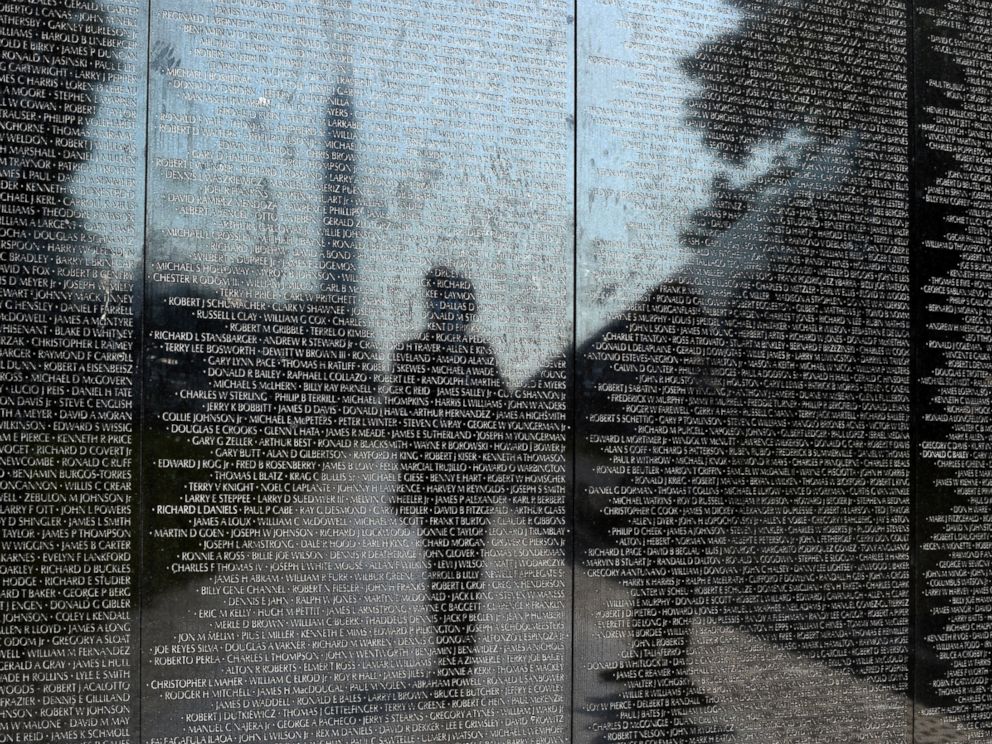 PHOTO: Visitors are reflected in the Vietnam Memorial in Washington, May 27, 2016.