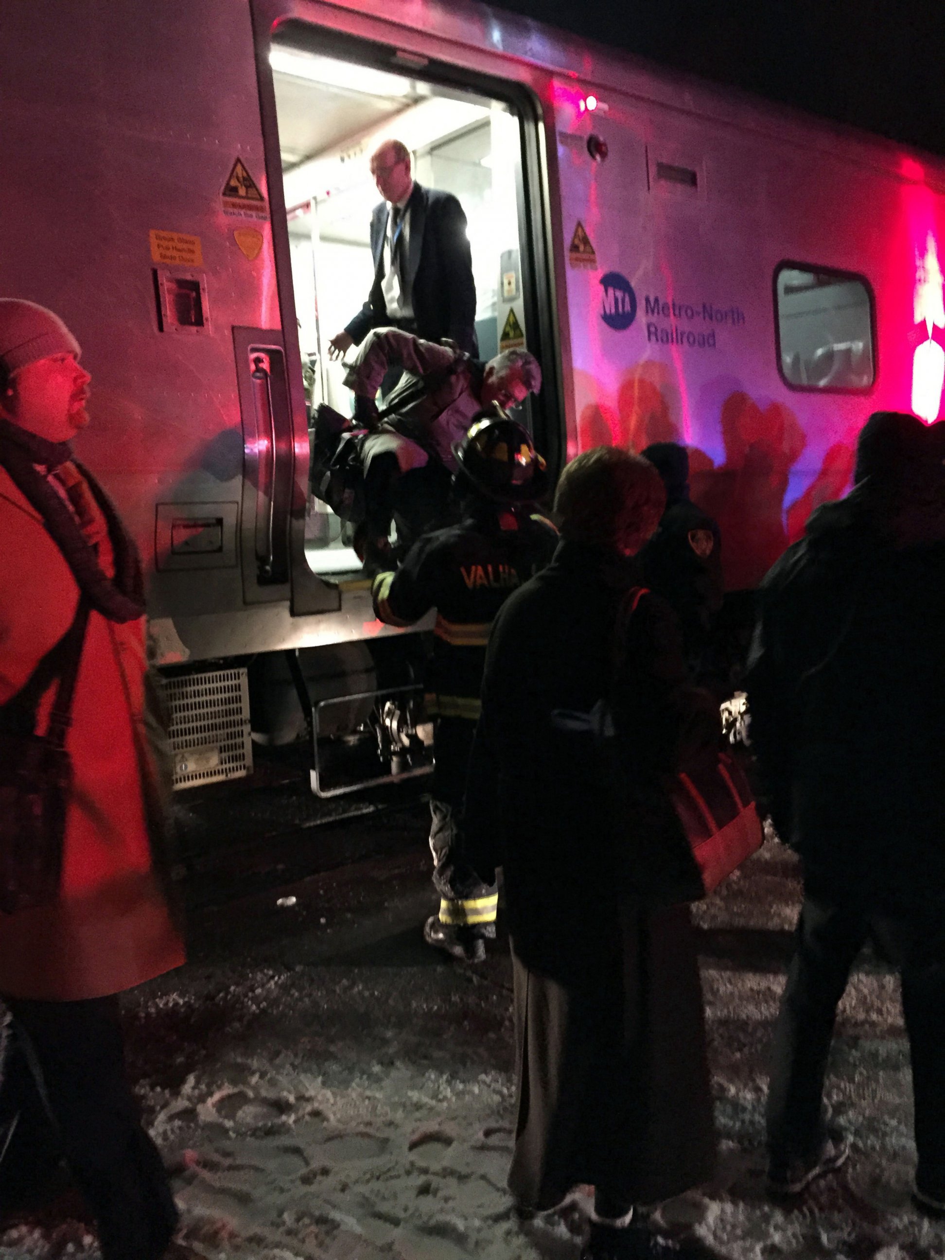 PHOTO: Passengers are assisted off a Metro-North Railroad passenger train in Valhalla, N.Y., Feb. 3, 2015. 