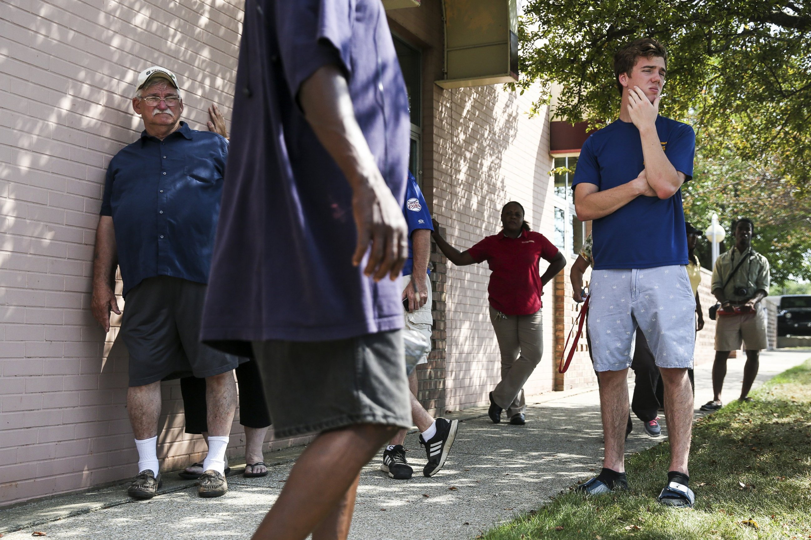 PHOTO: People wait for news outside Berrien County Courthouse on in St. Joseph, Michigan, where two bailiffs were shot and killed inside the courthouse before officers killed the gunman, July 12, 2016. 