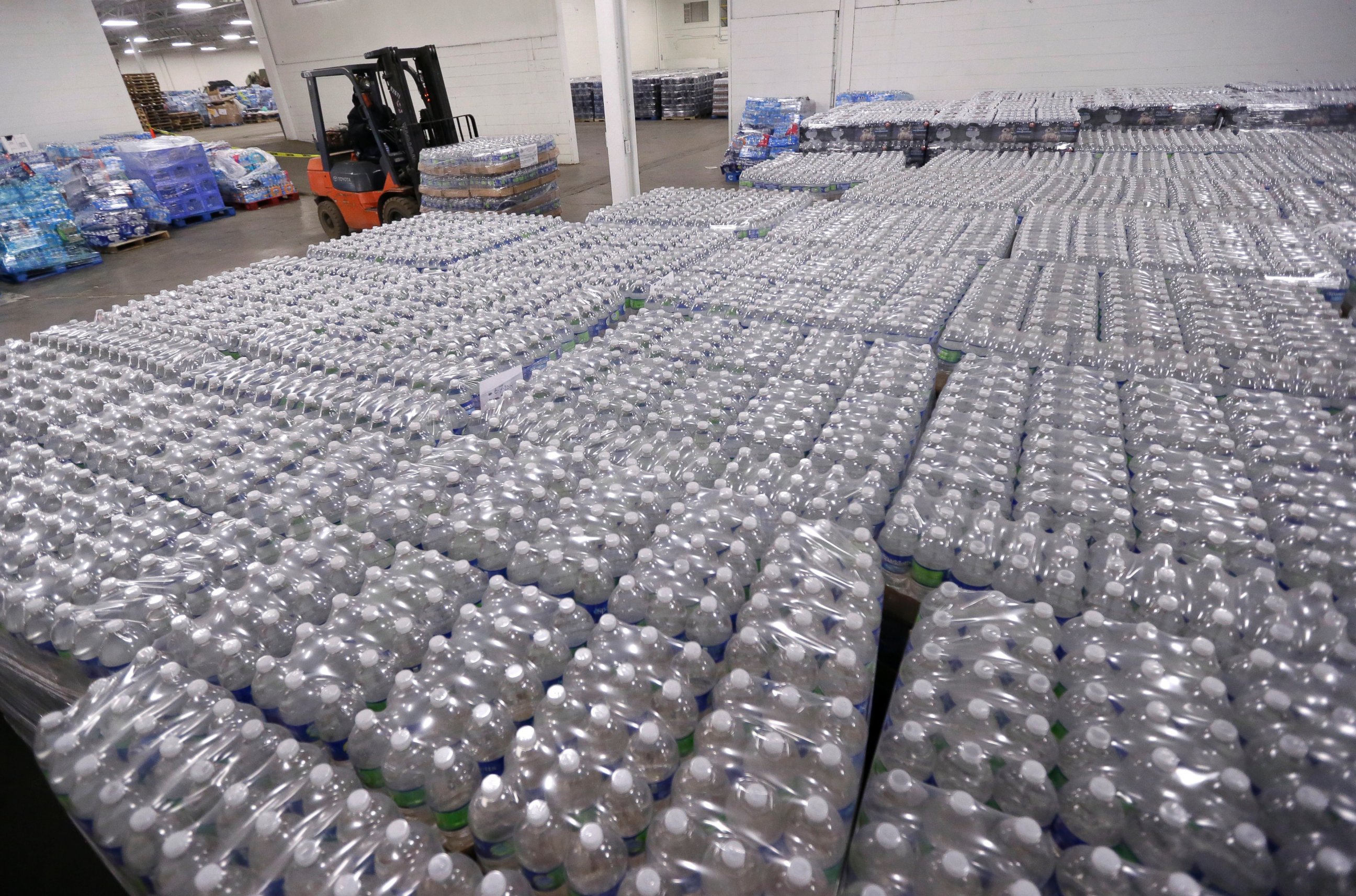 PHOTO: A forklift driver moves a pallet of water in a warehouse, Jan. 19, 2016, in Flint, Mich. 