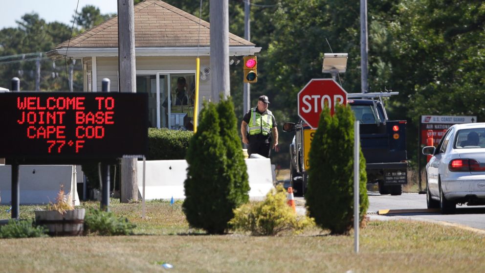 Vehicles are stopped by security personal as they enter a gate on Sept. 22, 2014, to Camp Edwards, Mass., on Cape Cod. 