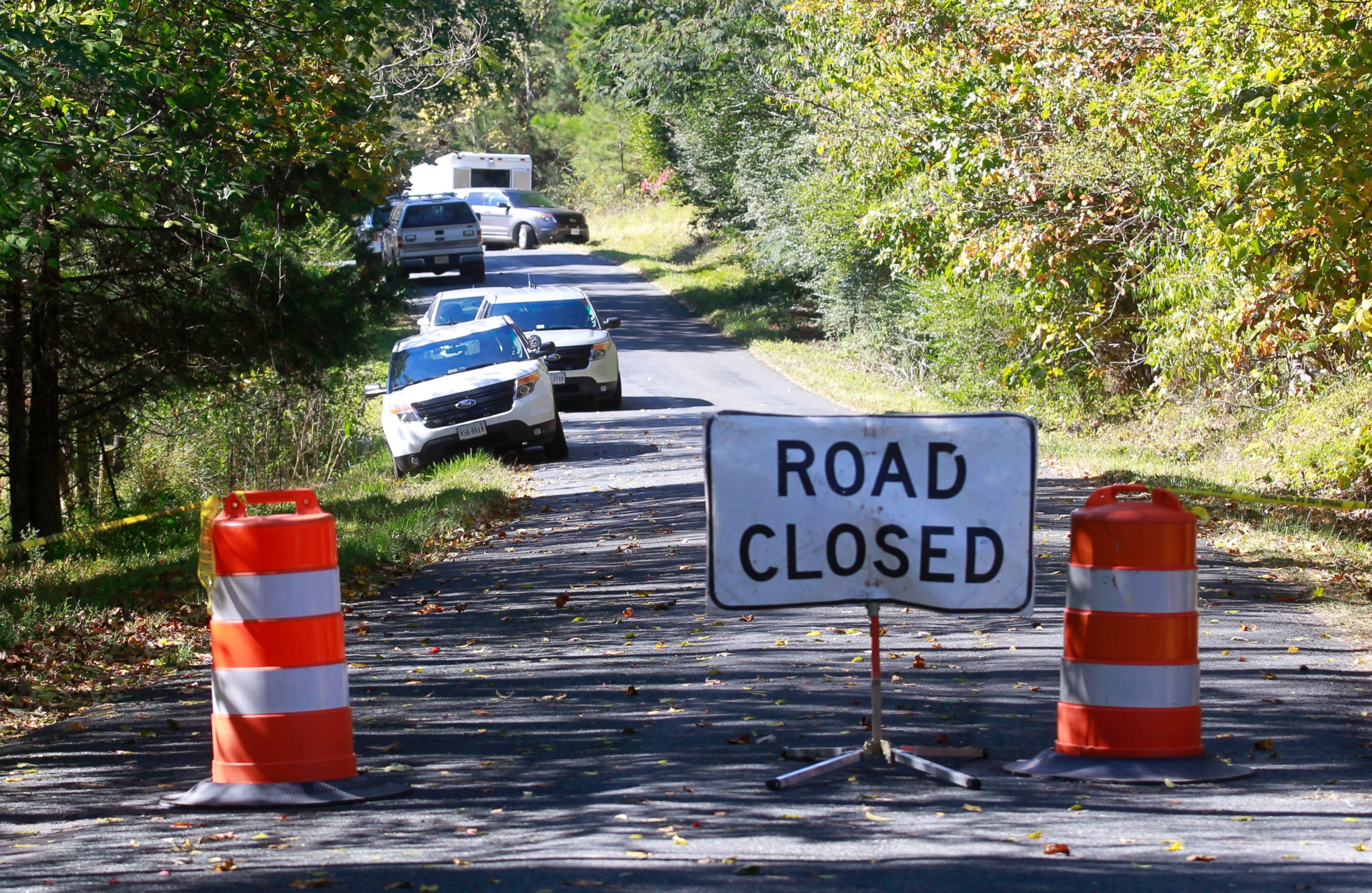 PHOTO: A road closed sign blocks traffic as authorities search a rural area where human remains were discovered in Albermarle County, Va., Oct. 19, 2014. 