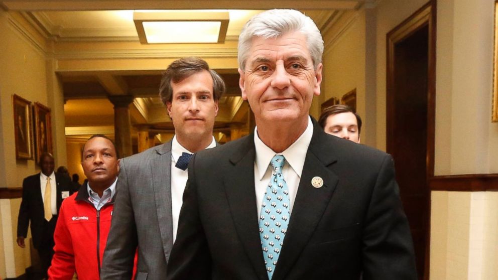 Gov. Phil Bryant walks on his way to a meeting of a youth jobs program board, at the Capitol in Jackson, Miss., April 1, 2016.