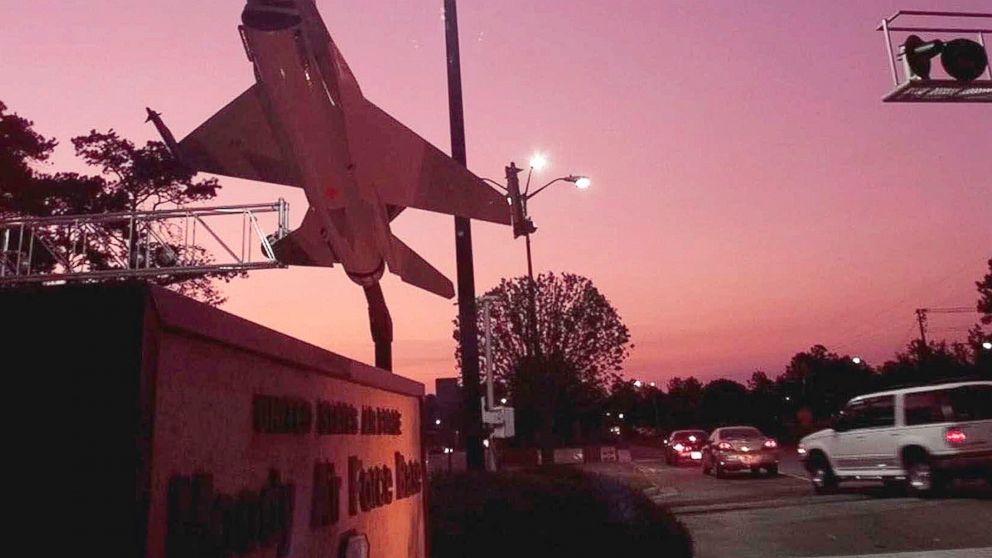 PHOTO: A mock F-16 fighter jet is silhouetted against the sky at sunrise as workers pass through security and make their way onto Moody Air Force Base, near Valdosta, Ga. 