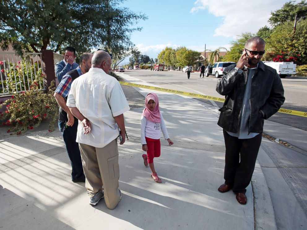 PHOTO: Members of the Islamic Center of Palm Springs wait behind a police barricade as authorities investigate a fire that damaged the Southern California mosque in Coachella, Calif., just east of Palm Springs, early Friday, Dec. 11, 2015.
