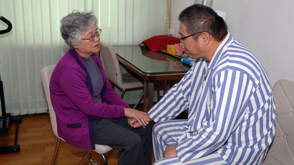 PHOTO: Kenneth Bae, right, an American man detained in North Korea for the past 11 months, and his mother Myunghee Bae talk each other during their meeting at a hospital in Pyongyang, Oct. 11, 2013.