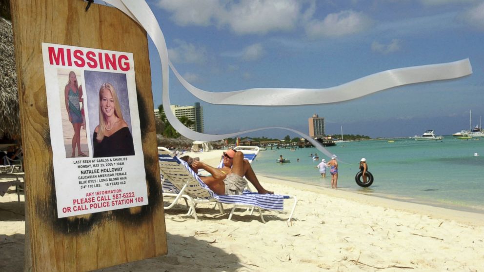 A missing poster for Natalee Holloway, a high school graduate of Mountain Brook, Alabama who disappeared while on a graduation trip to Aruba on May 30, 2005, is seen on Palm Beach where tourists sunbathe in Aruba, June 10, 2005.