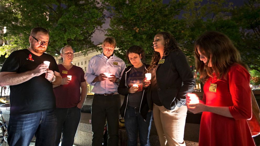 A small group holds a candle light vigil on Freedom Plaza to remember the victims of the shooting at the Washington Navy Yard, Sept. 16, 2013, in Washington.