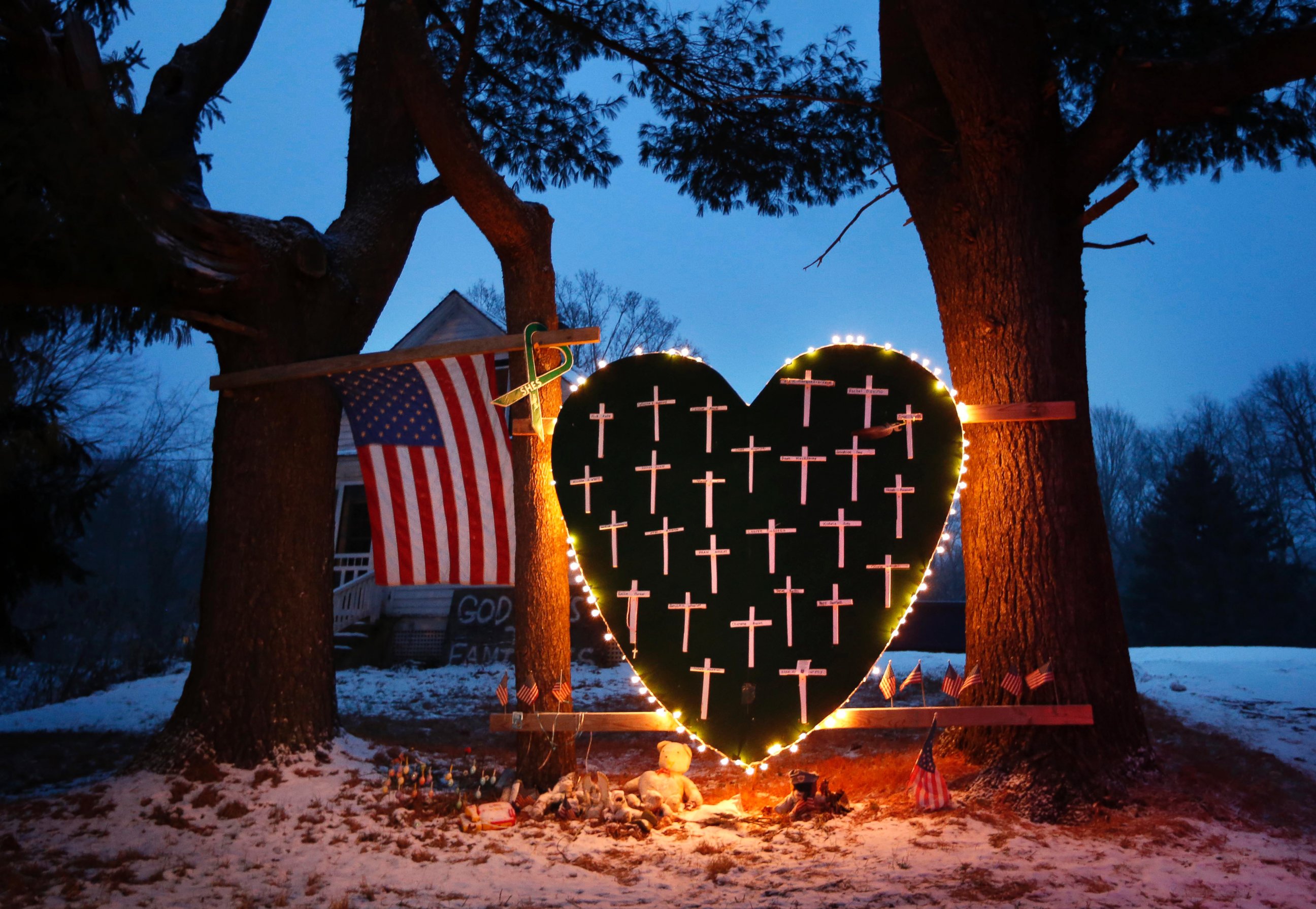 PHOTO: A memorial with crosses for the victims of the Sandy Hook Elementary School shooting massacre stands outside a home in Newtown, Conn., on the one-year anniversary of the shootings, Dec. 14, 2013.