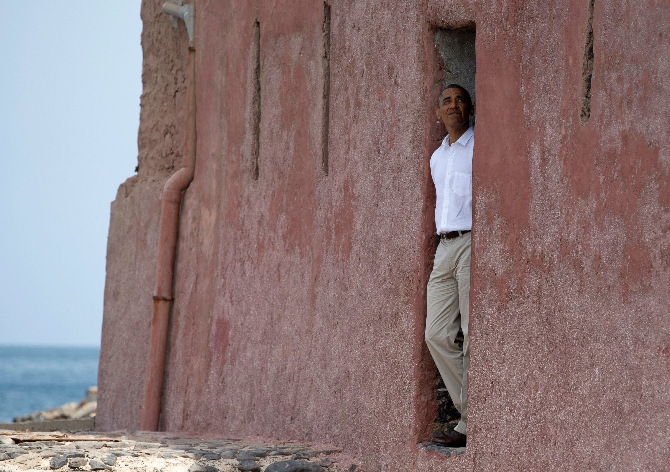 PHOTO: President Barack Obama looks out of the "door of no return" during a tour of Goree Island in this  June 27, 2013 file photo, in Goree Island, Senegal.