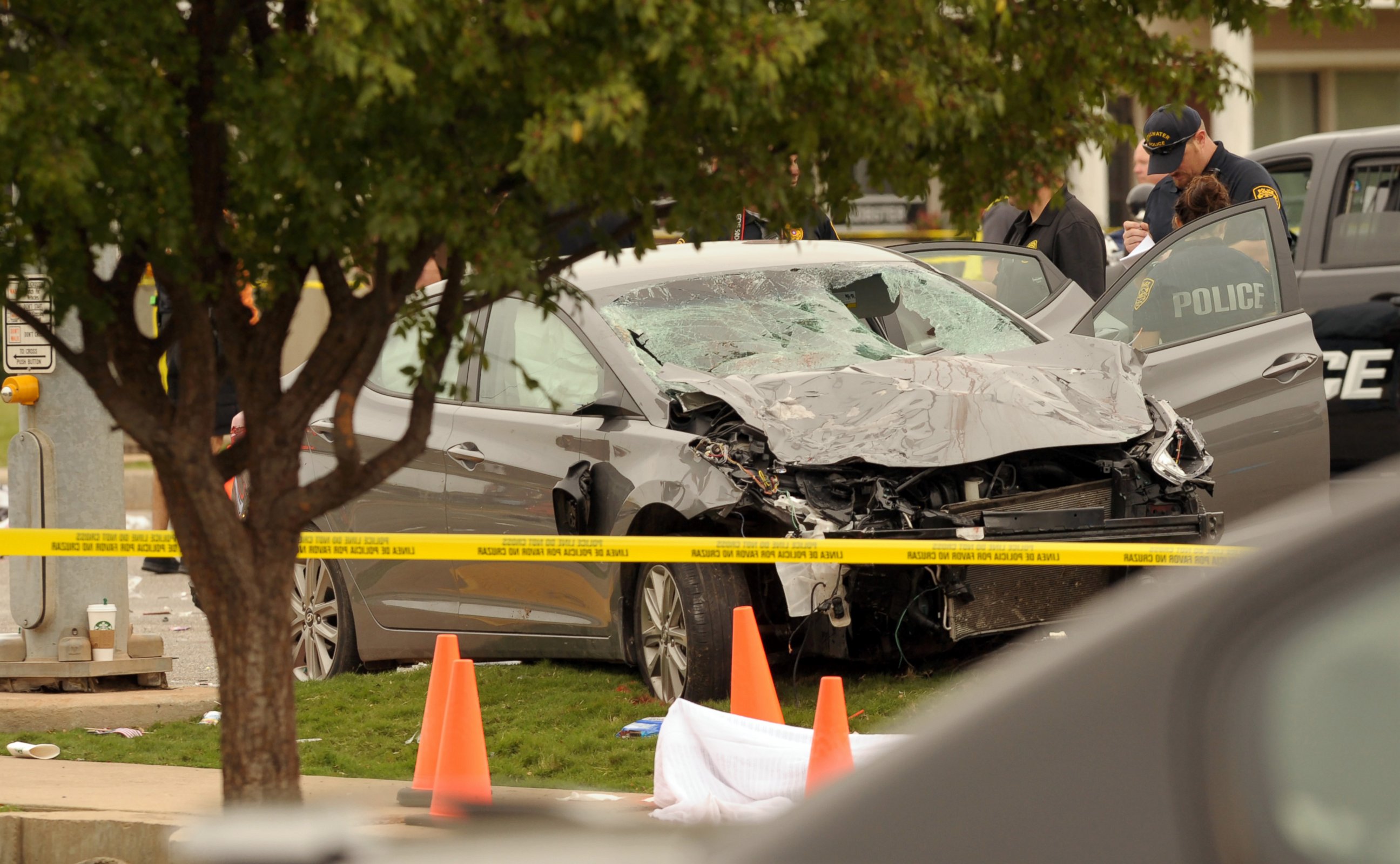 PHOTO:Police investigate a damaged car after the vehicle crashed into a crowd of spectators during the Oklahoma State University homecoming parade, causing multiple injuries, Oct. 24, 2015, in Stillwater, Oka. 