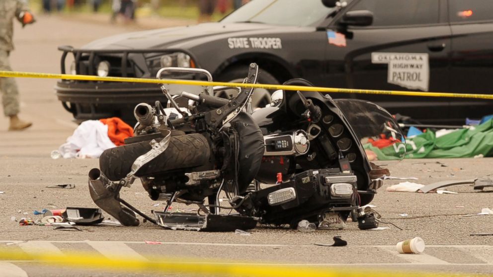 PHOTO: A damaged police motorcycle rests in the intersection after a vehicle crashed into a crowd of spectators during the Oklahoma State University homecoming parade, causing multiple injuries, Oct. 24, 2015 in Stillwater, Oka.