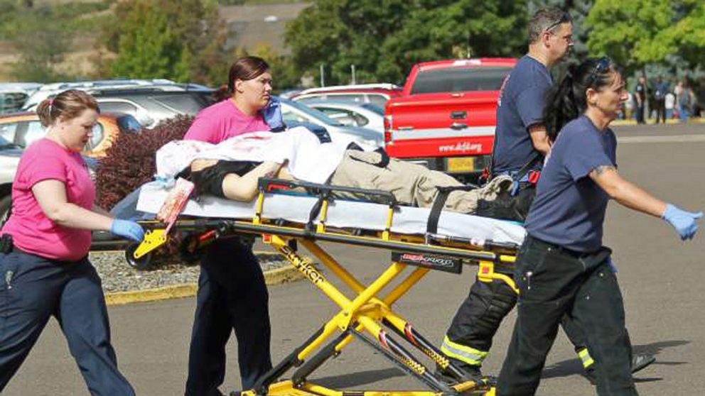 PHOTO: Authorities carry a shooting victim away from the scene after a gunman opened fire at Umpqua Community College in Roseburg, Ore., Oct. 1, 2015.