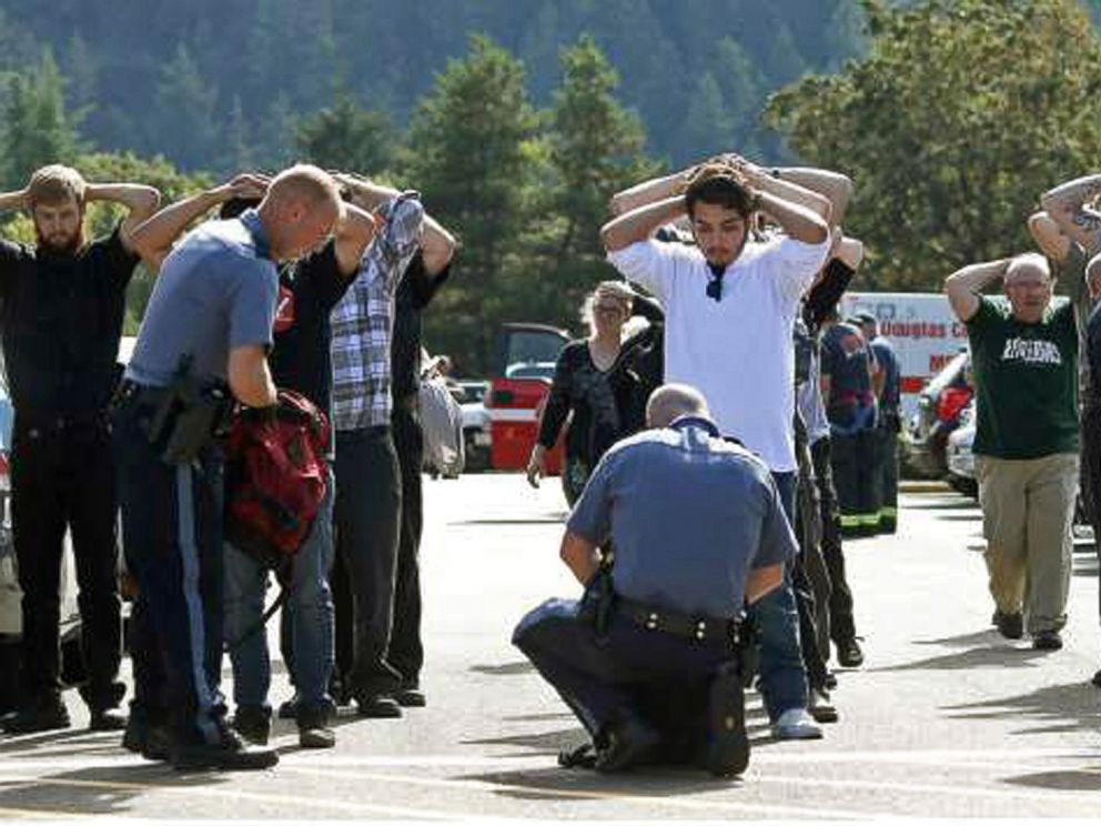 PHOTO: Police search students outside Umpqua Community College in Roseburg, Ore., Oct. 1, 2015, following a deadly shooting at the college.