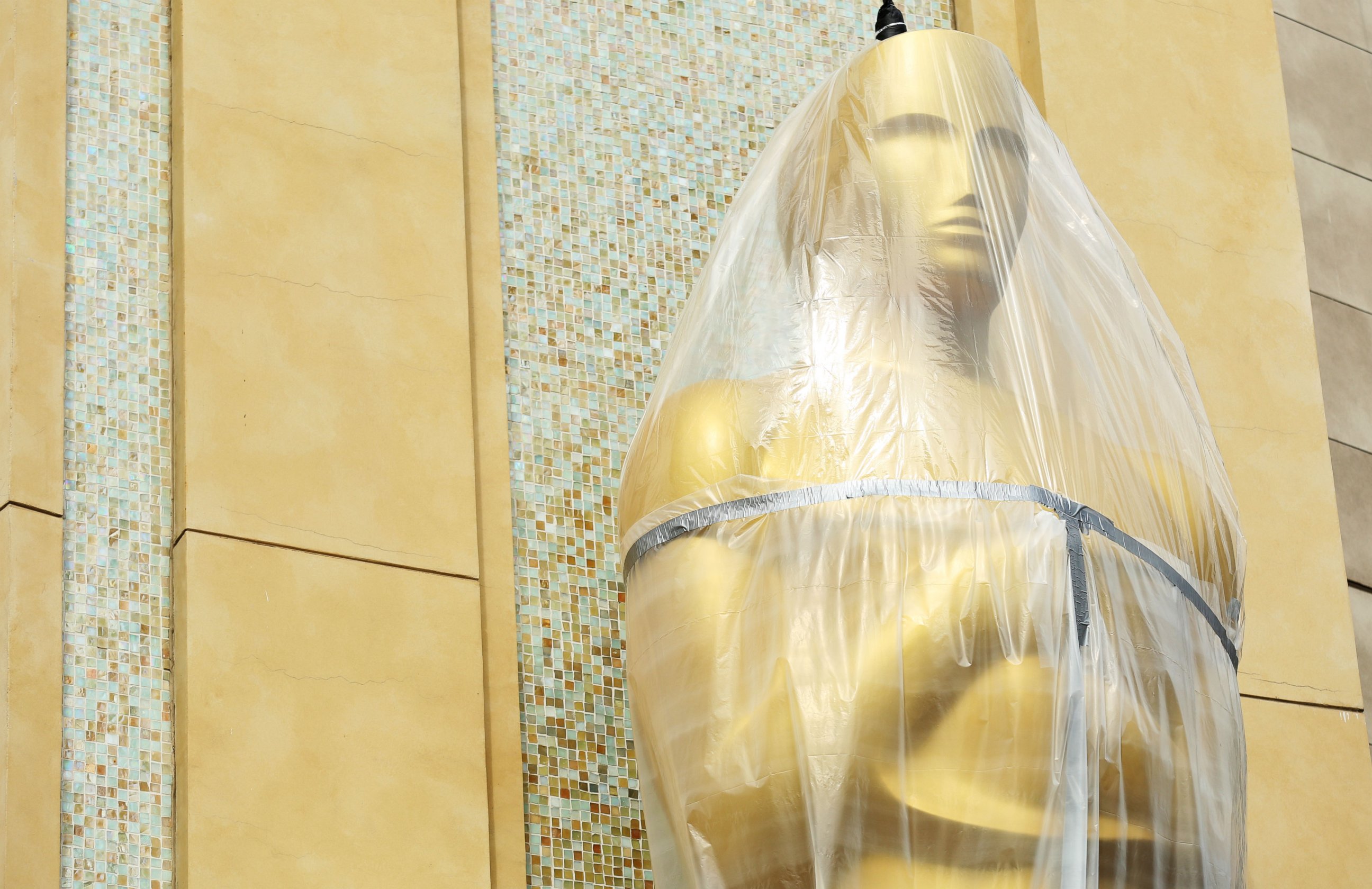 PHOTO: An Oscar statue is covered in plastic as preparations are made for the 86th Academy Awards in Los Angeles, Wednesday, Feb. 26, 2014. 