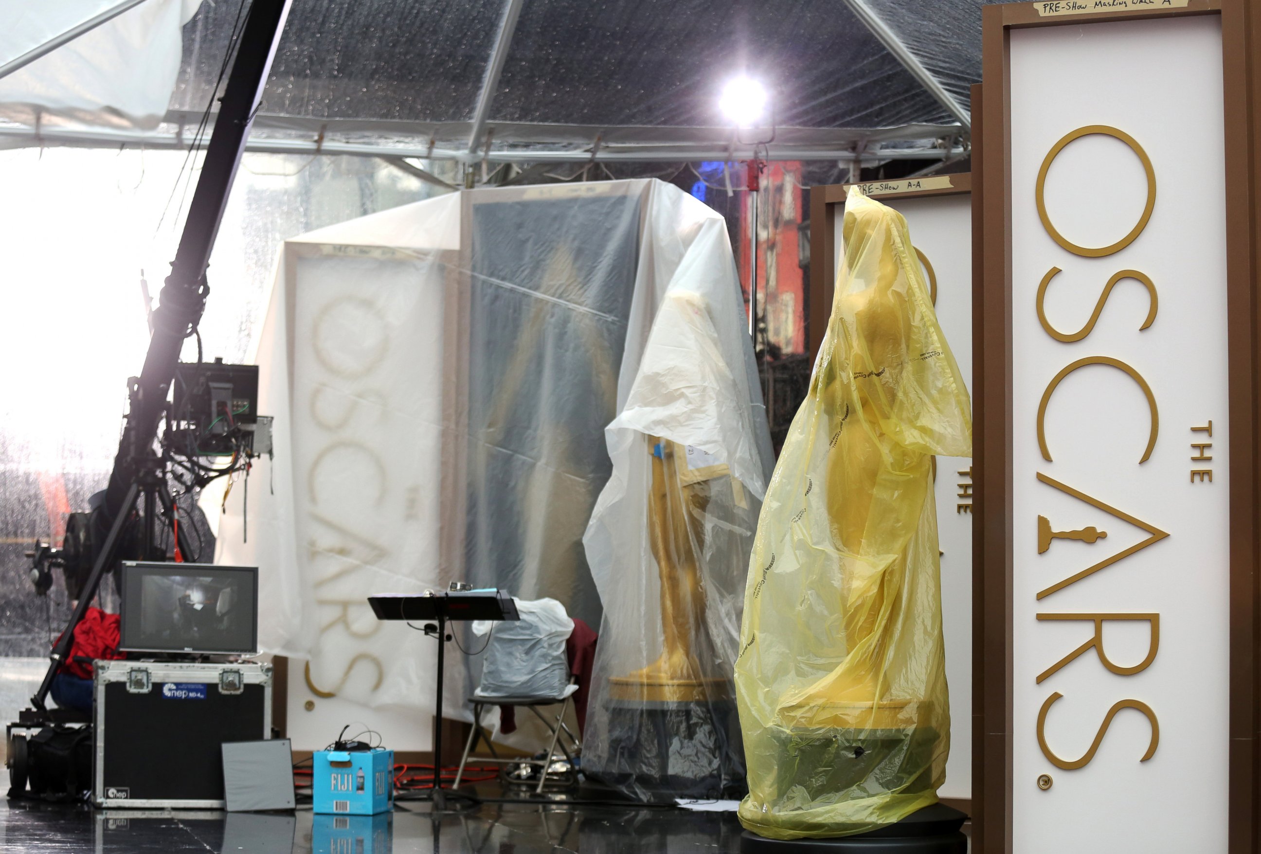 PHOTO: A pair of Oscar statues are seen on the red carpet as preparations are made during rainy weather for the 86th Academy Awards in Los Angeles, Friday, Feb. 28, 2014.