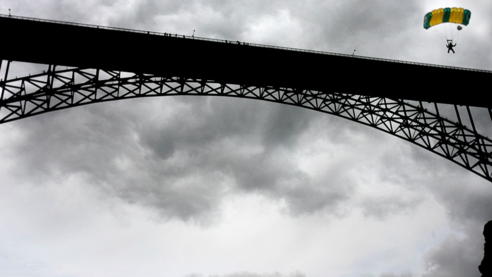 In this file photo, a BASE jumper guides his chute to the riverbank after leaping from the Perrine Bridge in Twin Falls, Idaho on May 28, 2006.