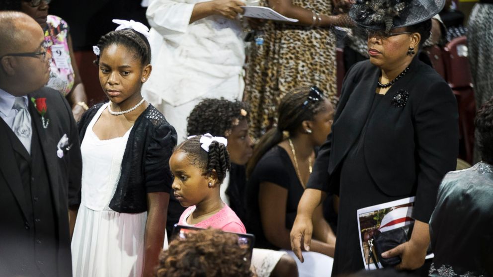 Sen. Clementa Pinckney's wife Jennifer Pinckney, right, and daughters Eliana, left, and Malana walk in for his funeral service, June 26, 2015, in Charleston, S.C.