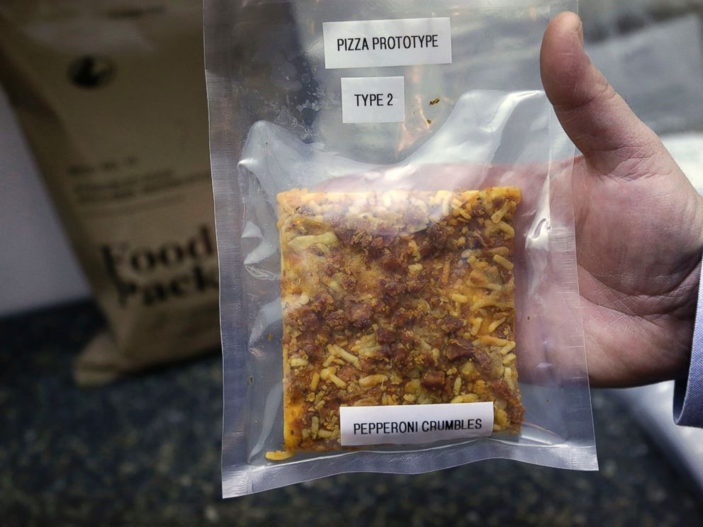 PHOTO: A packet containing a slice of prototype pizza is displayed by public affairs officer David Accetta at the U.S. Army Natick Soldier Research, Development and Engineering Center, in Natick, Mass., Feb. 6, 2014.