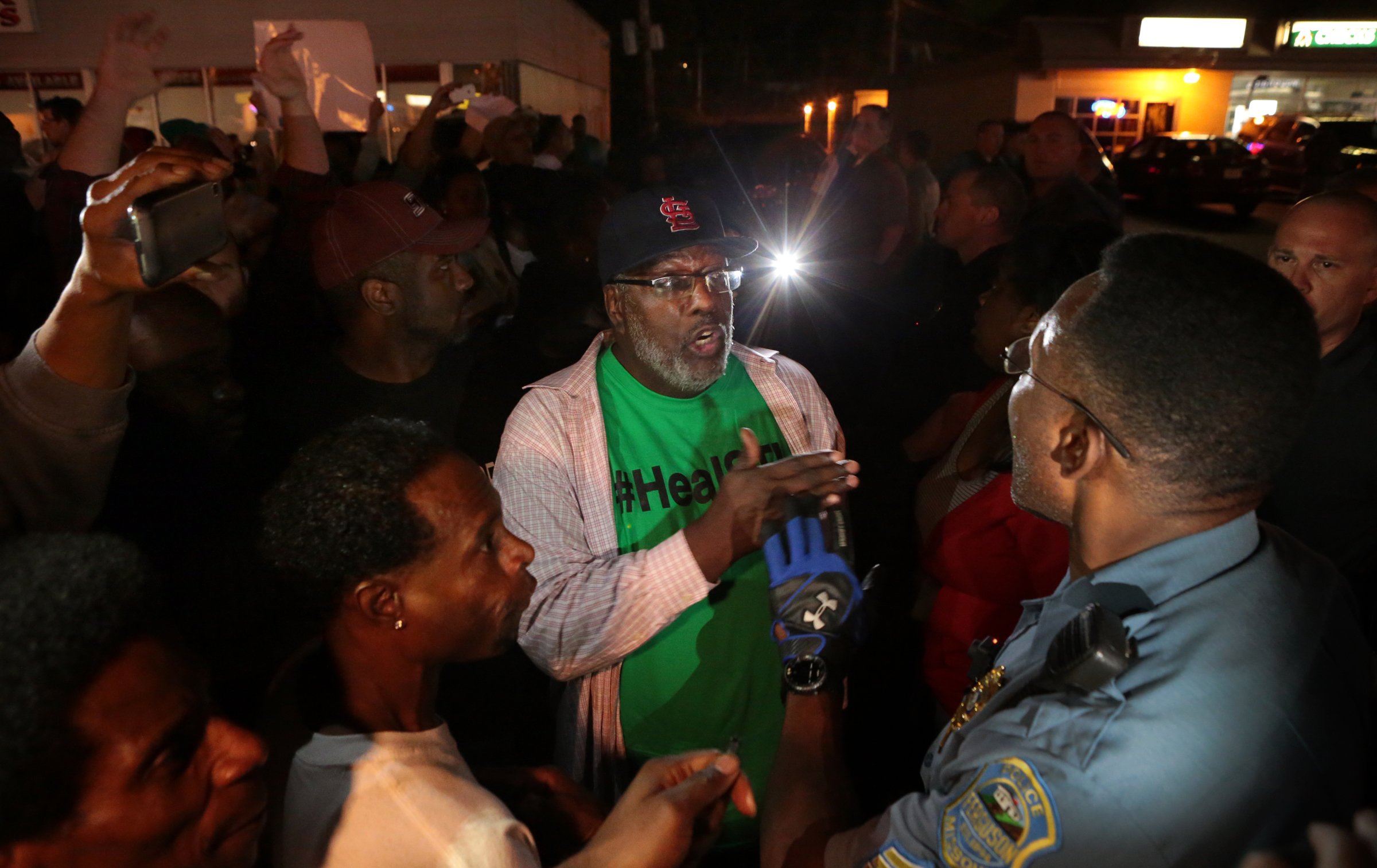 PHOTO: Protesters argue with a Ferguson sergeant who was trying to get them to disperse the area on West Florissant Avenue in Ferguson, Mo., Sept. 23, 2014.