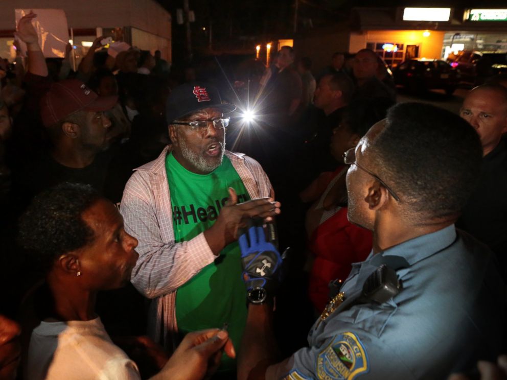 PHOTO: Protesters argue with a Ferguson sergeant who was trying to get them to disperse the area on West Florissant Avenue in Ferguson, Mo., Sept. 23, 2014.