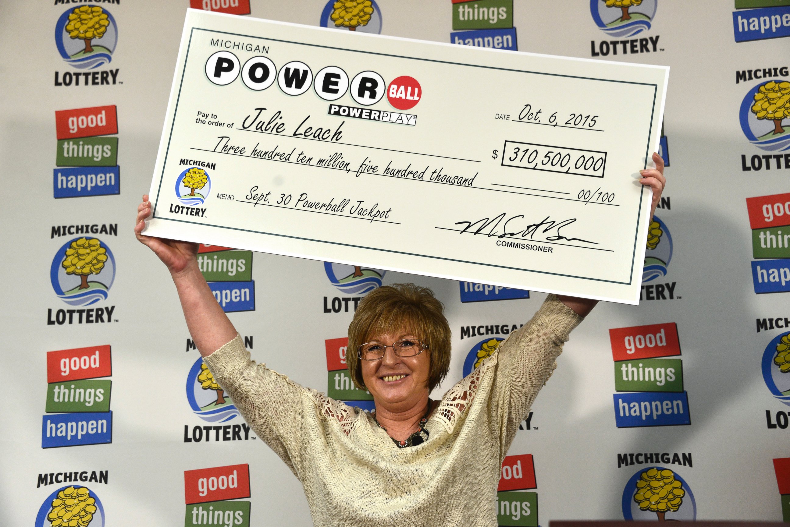 PHOTO: Julie Leach holds her $310 Million check aloft on Oct. 6, 2015. She was the sole winner of the Powerball jackpot.