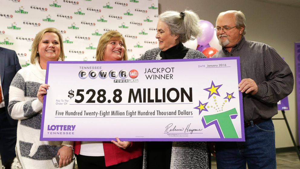PHOTO: Rebecca Hargrove, second from right, president and CEO of the Tennessee Lottery, presents a ceremonial check to John Robinson, right; his wife, Lisa, second from left; and their daughter, Tiffany, left; on Jan. 15, 2016, in Nashville, Tenn. 
